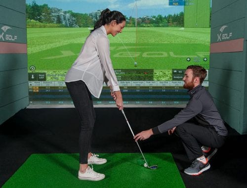 X-Golf Coach Giving Female Player Golf Lesson