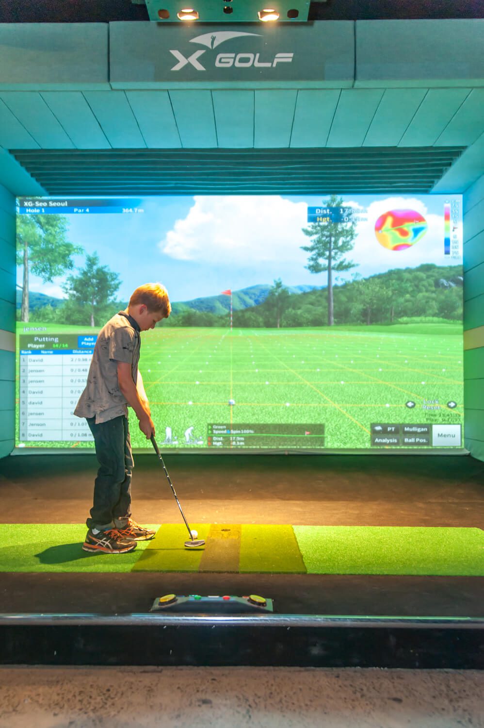 Boy playing X-Golf Simulator