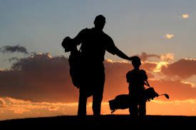 Father & Son walking Golf Course at Sunset