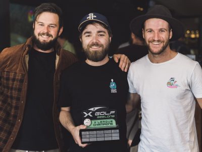 3 men holding trophy