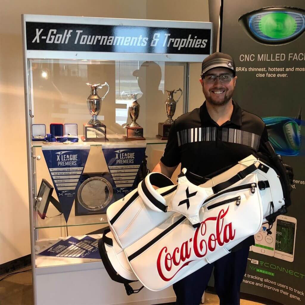 man holding coca-cola golf bag