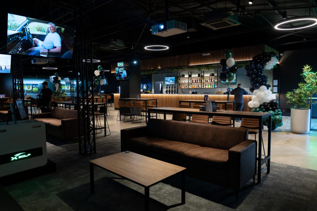 X-Golf Morley entertainment area with a couch and Sports Bar