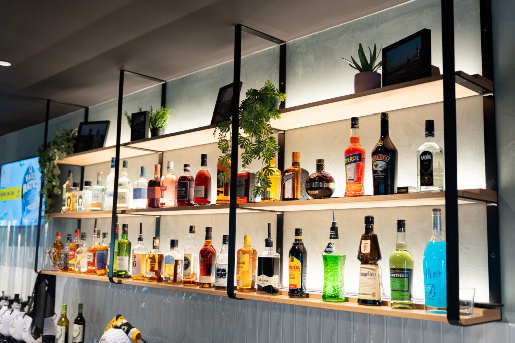 Backlit spirits display at X-Golf Morley bar shelves