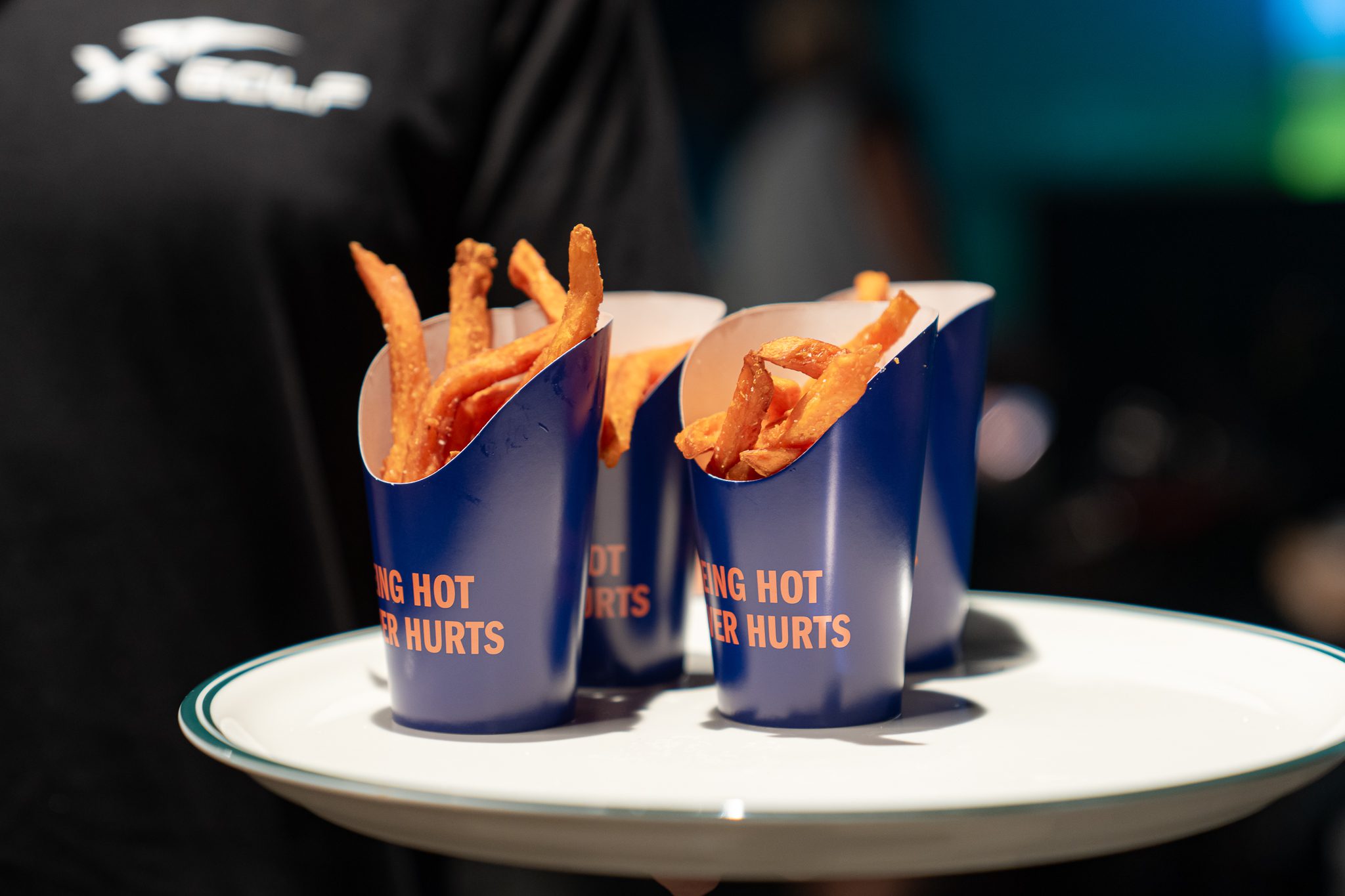 Crispy fries served in cups at X-Golf Morley venue
