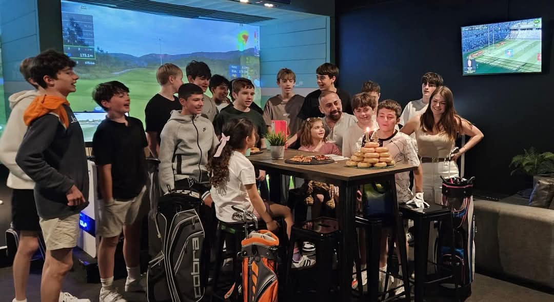 Birthday group celebrating together inside X-Golf Macarthur venue