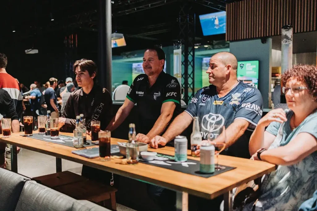 Group socialising with drinks at X-Golf Townsville venue