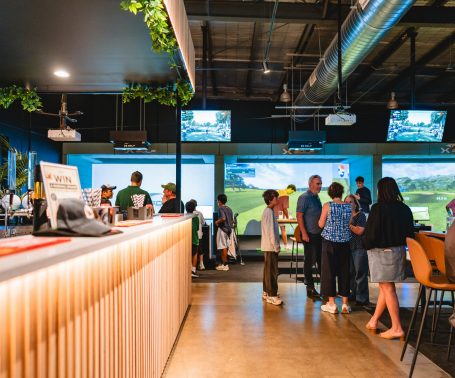 virtual golf simulator bays and bar area at X-Golf Surrey Hills